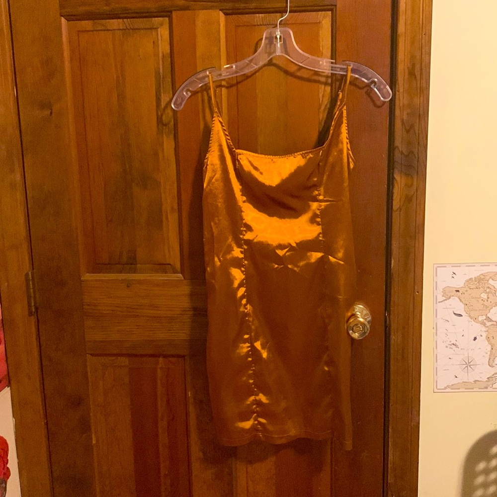 Satin orange gold toned dress. For women sizes 4-6. Worn once. Fitted bodycon